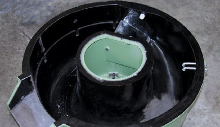 The same vibratory bowl after relining, with a fresh black polyurethane lining installed